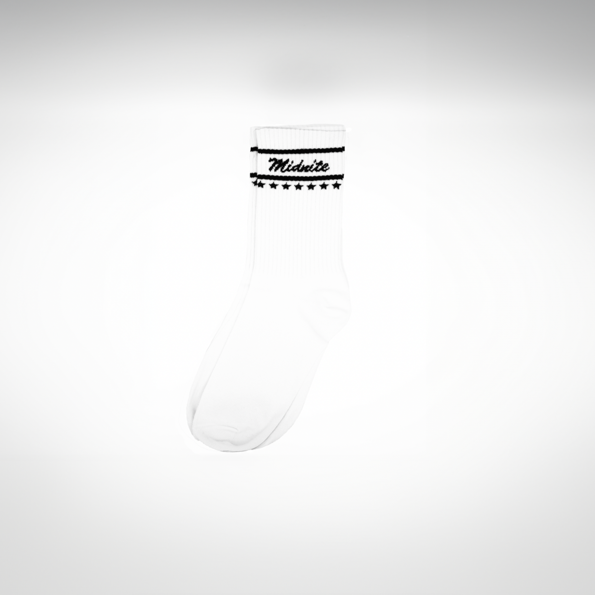 Midnite Club white streetwear socks – ribbed athletic crew socks with black cursive logo and star detailing, inspired by retro motorsport and underground fashion.